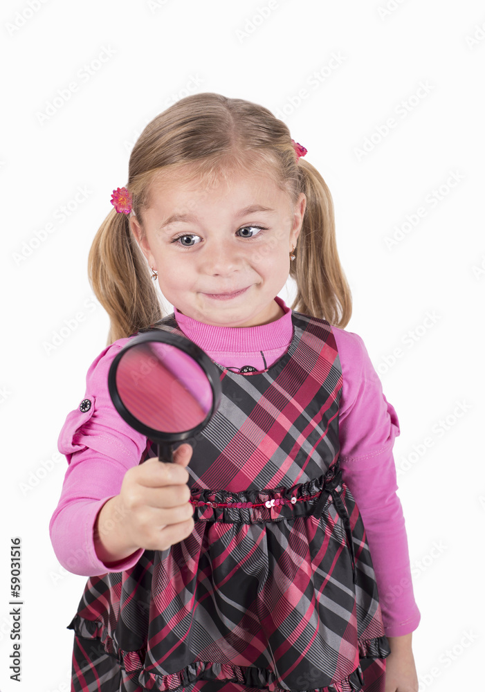 Little girl looking through a magnifying glass carefully. Little girl looking through a magnifying glass carefully.