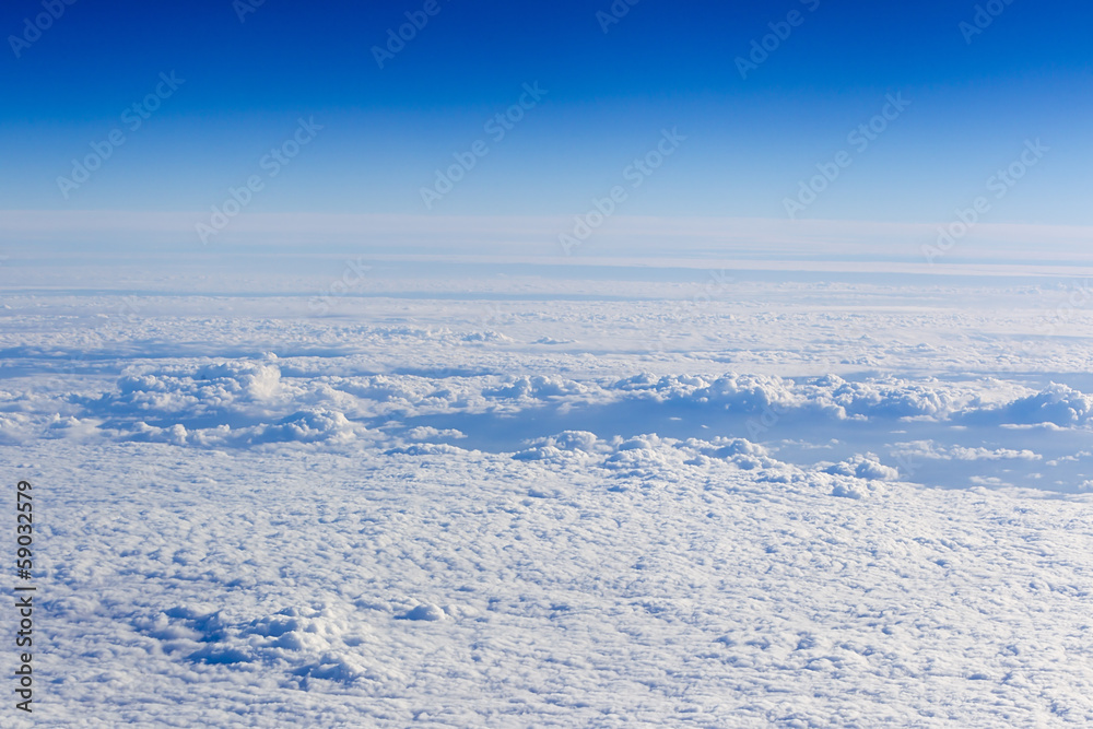 clouds. top view from the window of an airplane flying in the cl