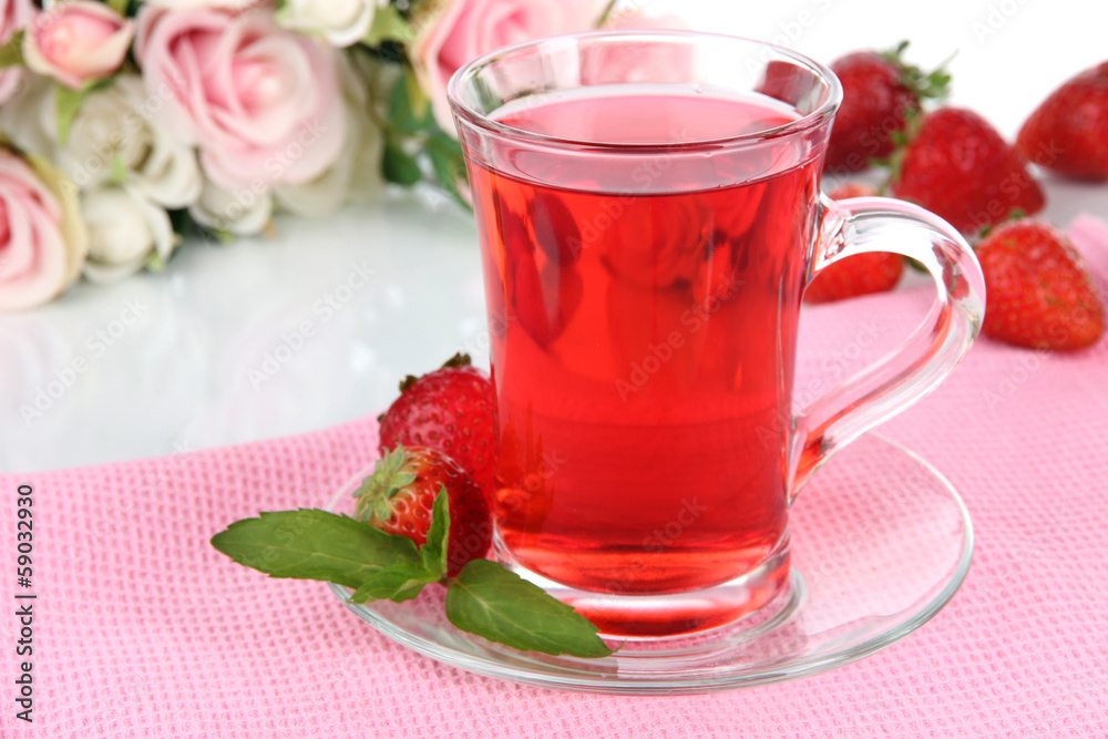 Delicious strawberry tea on table on white background Delicious strawberry tea on table on white background
