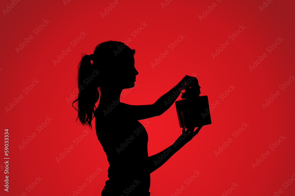 Silhouette of woman with gift