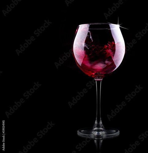 glass of red splashing wine