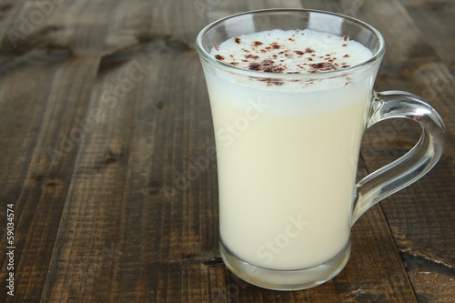 Cup of eggnog on wooden background © Africa Studio