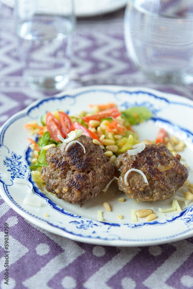 Minced beef meat ball burger patties with some salad on the side