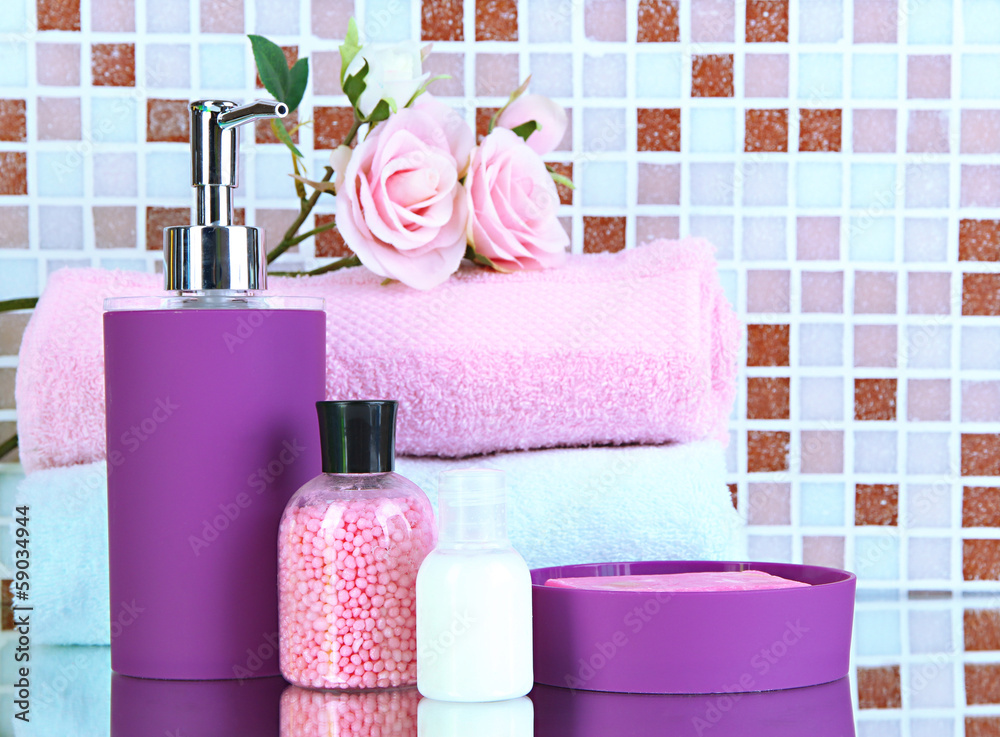 Cosmetics and bath accessories on mosaic tiles background Cosmetics and bath accessories on mosaic tiles background