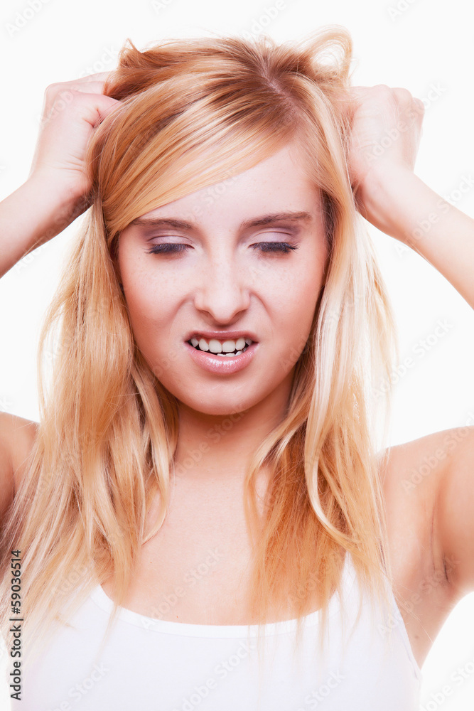 Stress. Young woman frustrated pulling her hair on white Stress. Young woman frustrated pulling her hair on white