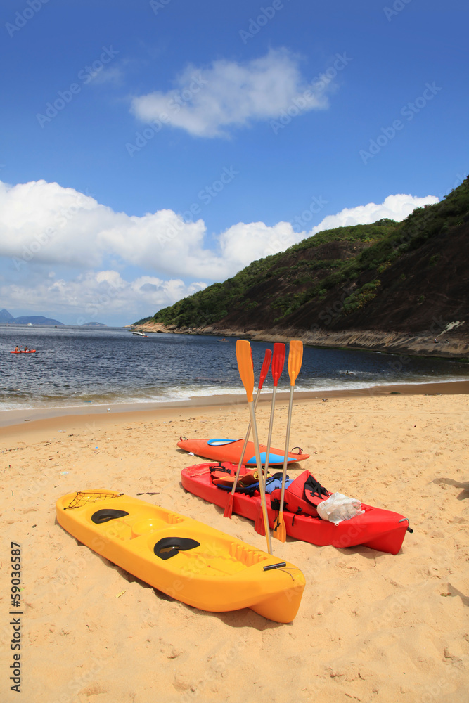 Colorful kayaks and sailing boats for rent