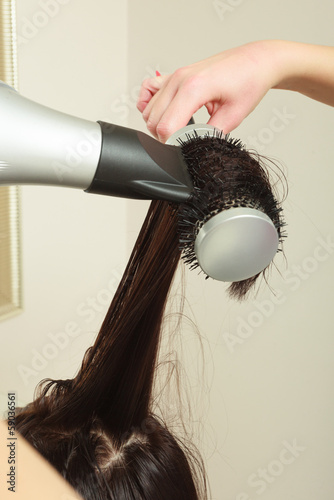 Hairstylist drying hair woman client. Hairdressing beauty salon
