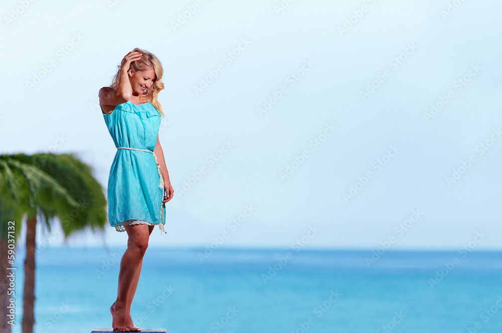 beautiful young girl posing in front of the sea