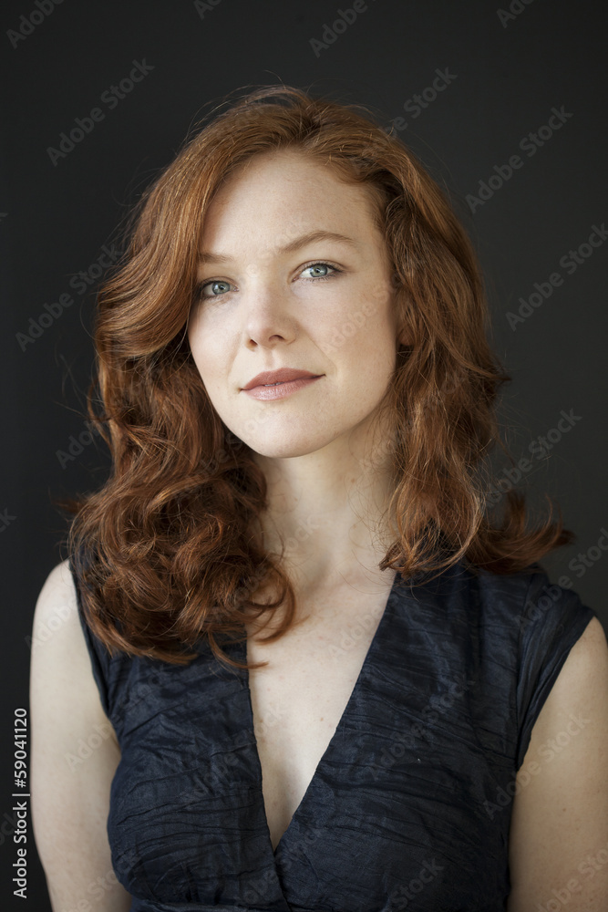 Young Woman with Beautiful Blue Eyes and Red Hair