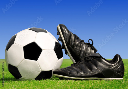 soccer ball and shoes in grass