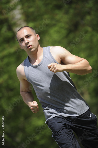 Young man running in the woods