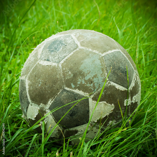 old ball put on green grass