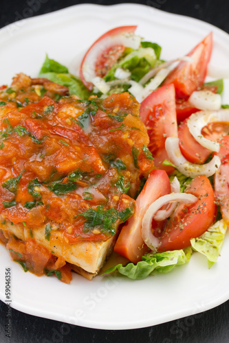 chicken with sauce and salad