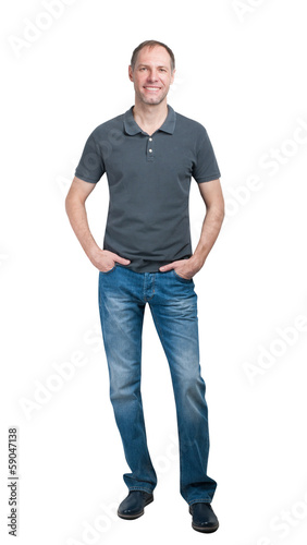 Smiling man in grey t-shirt and jeanse isolated on white backgro