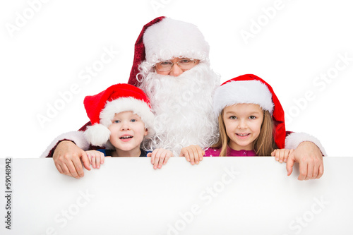 Old classic Santa Claus hugging two little kids.