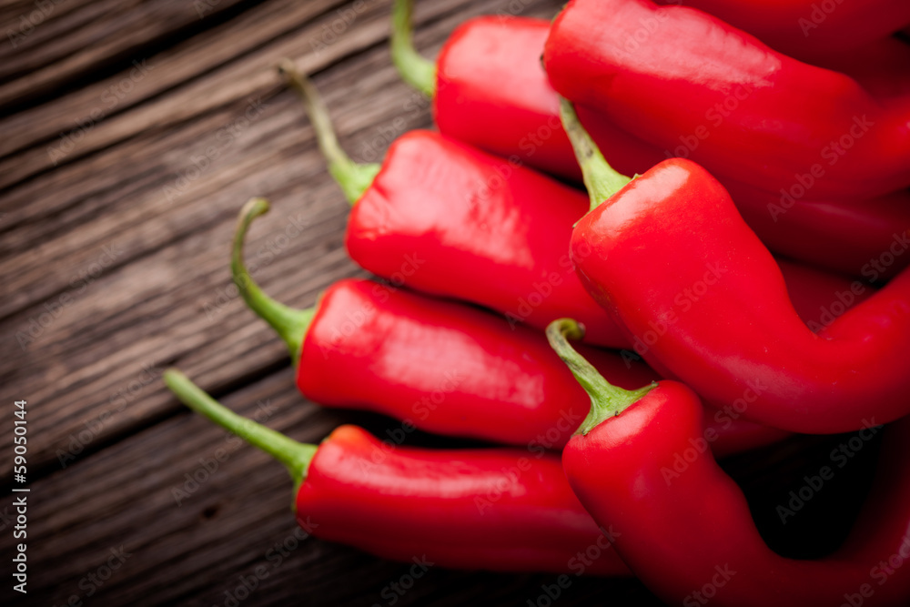 Fresh red chilli on a wooden table Fresh red chilli on a wooden table