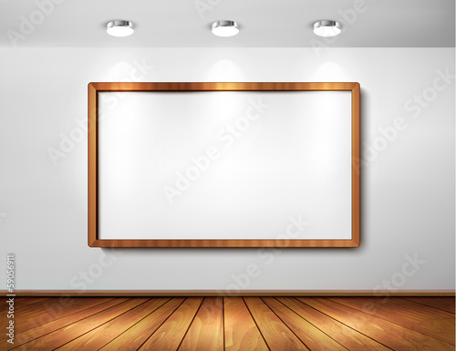 Empty wooden frame on wall with spotlights and wooden floor.