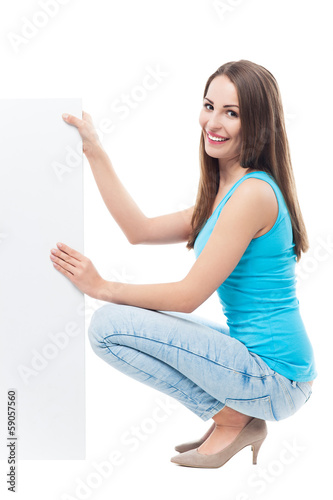 Woman crouching by blank board