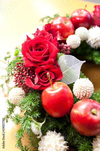 Christmas wreath made by roses and apples. 