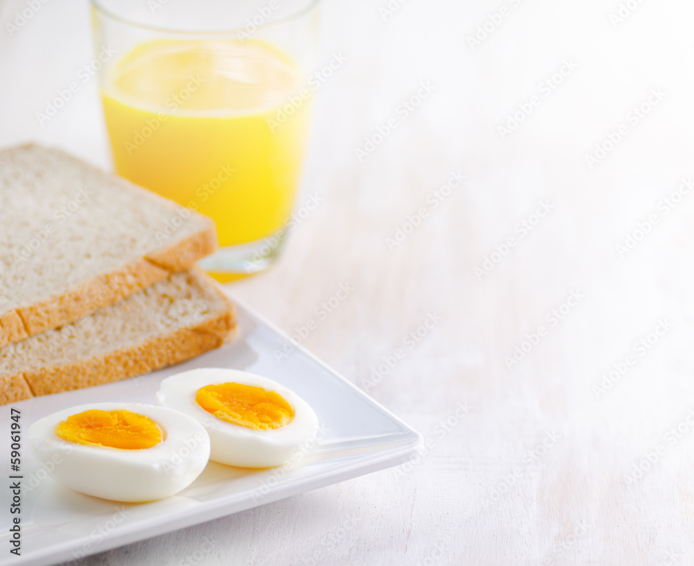 Boiled egg, toasts and orange juice. Boiled egg, toasts and orange juice.
