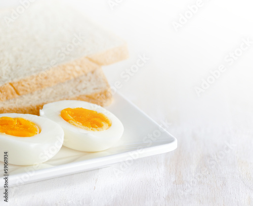 Boiled egg and toasts on white plate