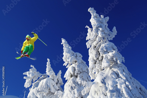 Skier against blue sky in high mountains #59061986