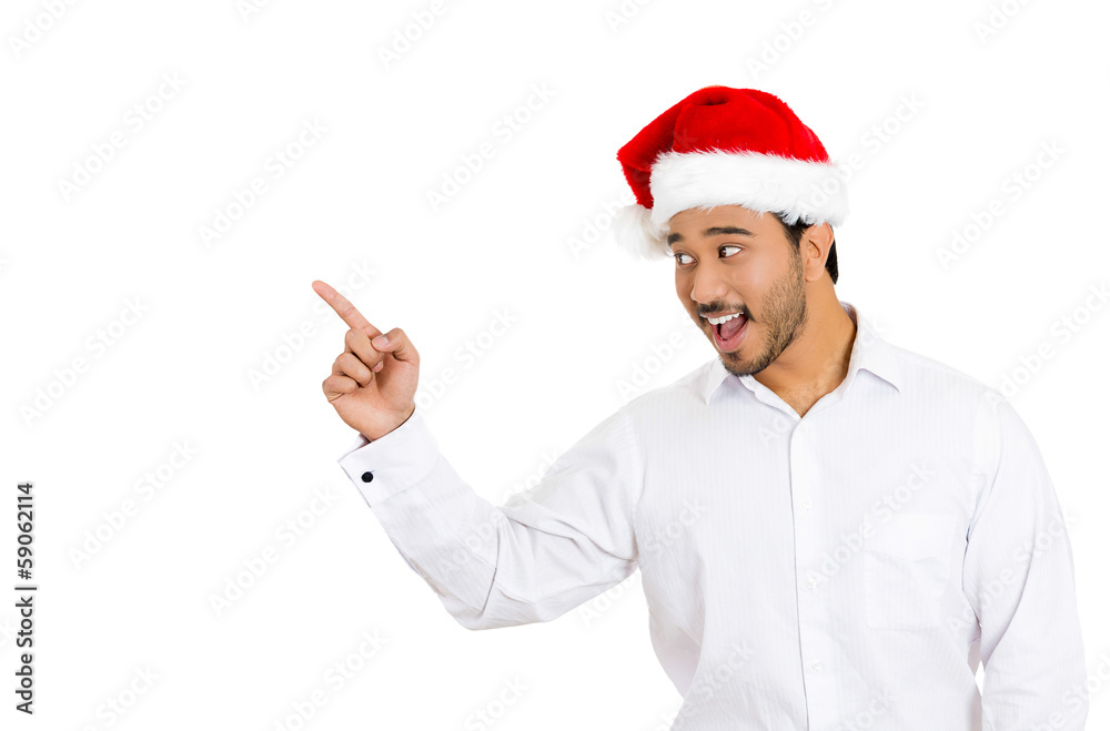 Happy christmas man pointing at copy space