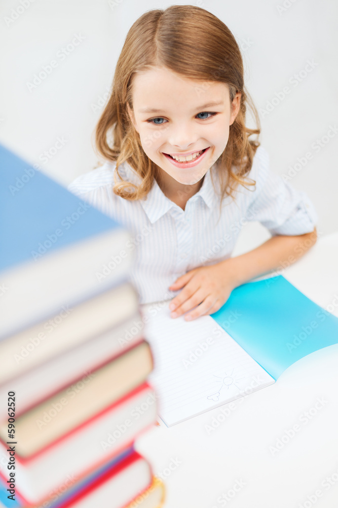 smiling little student girl with many books smiling little student girl with many books