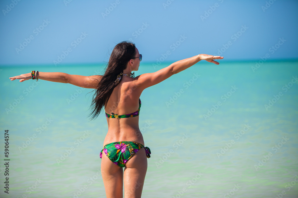 Naklejka premium Young woman enjoying the holiday spread her hands on a white,