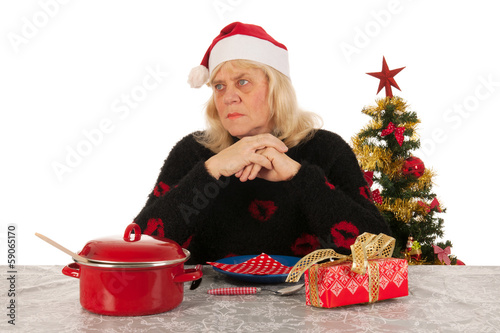 Woman of mature age alone with Christmas photo