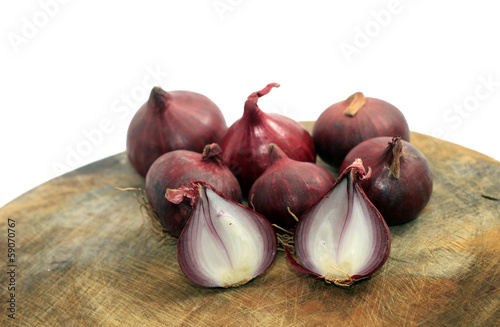 shallots on wooden cutting board isolated on white