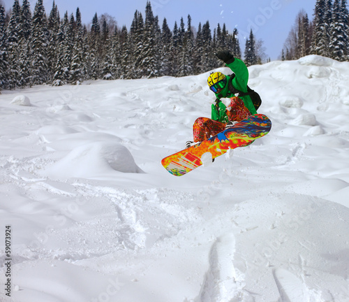 Snowboarder jumping photo