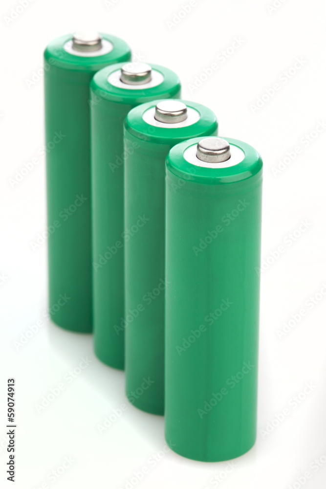 Four green batteries with blank covers Four green batteries with blank covers