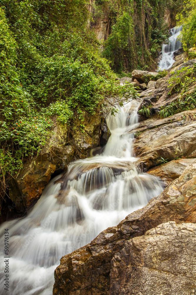 Naklejka premium The long exposure image of a beautiful waterfall in the forest