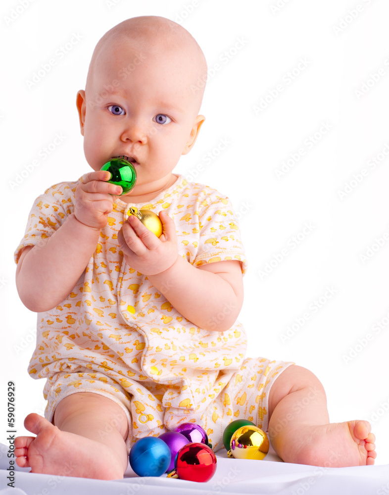 Baby playing with Christmas decoration Baby playing with Christmas decoration