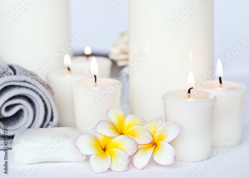 Three Plumeria flower with massage oil and balsam in bowl 