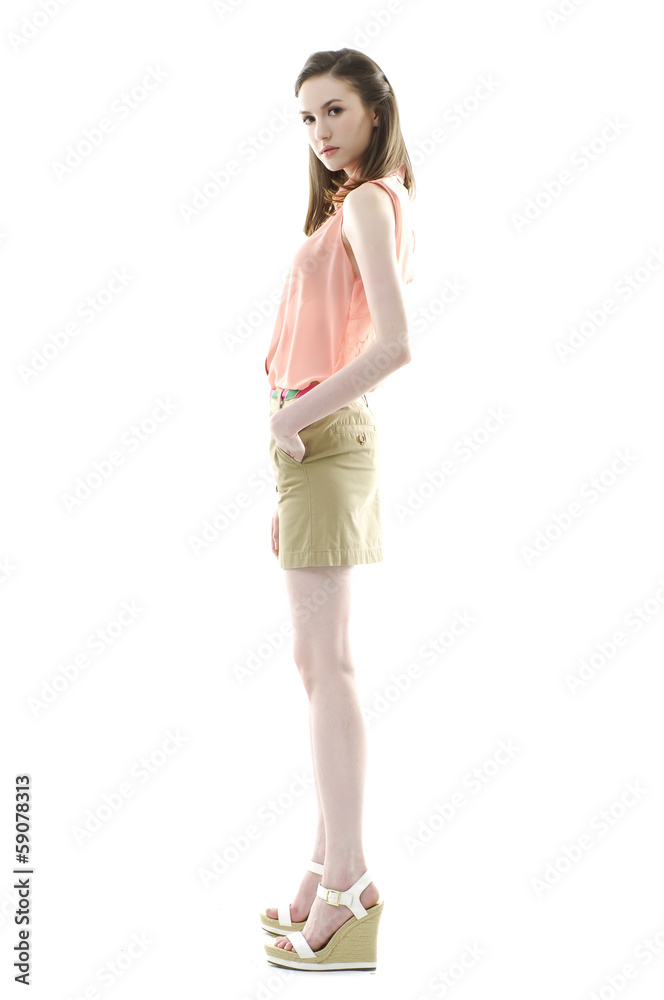 Full length side view young fashion model posing on white Full length side view young fashion model posing on white