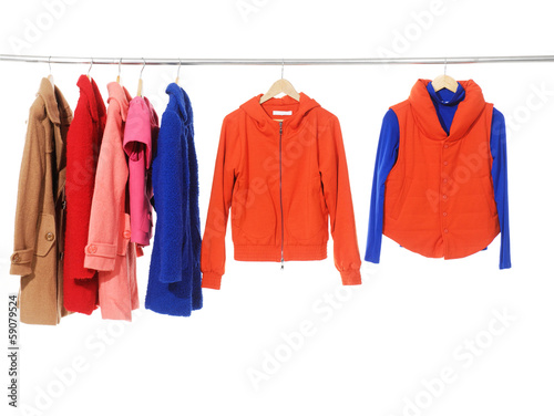 female fashion clothing with set of coat on hangers © inchic