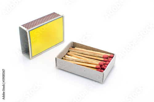 Matches in a matchbox on a white background with copy space