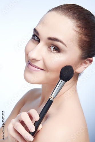 Beauty Girl with Makeup Brushes. Natural Make-up for Brunette Wo