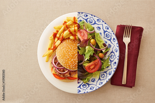 Low fat salad against greasy burger