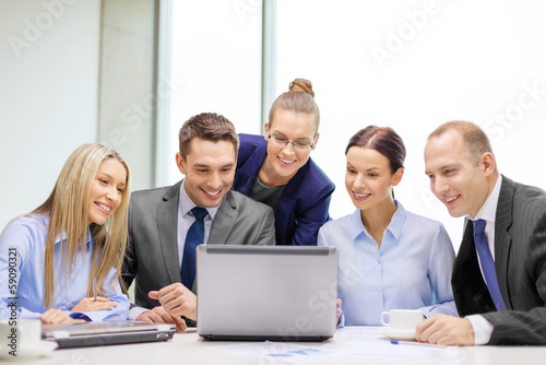 business team with laptop having discussion