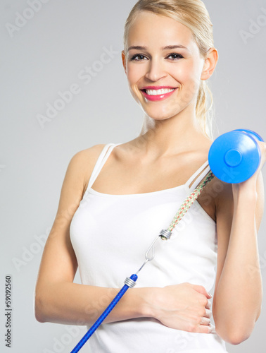 Woman exercising with dumbbells and growth