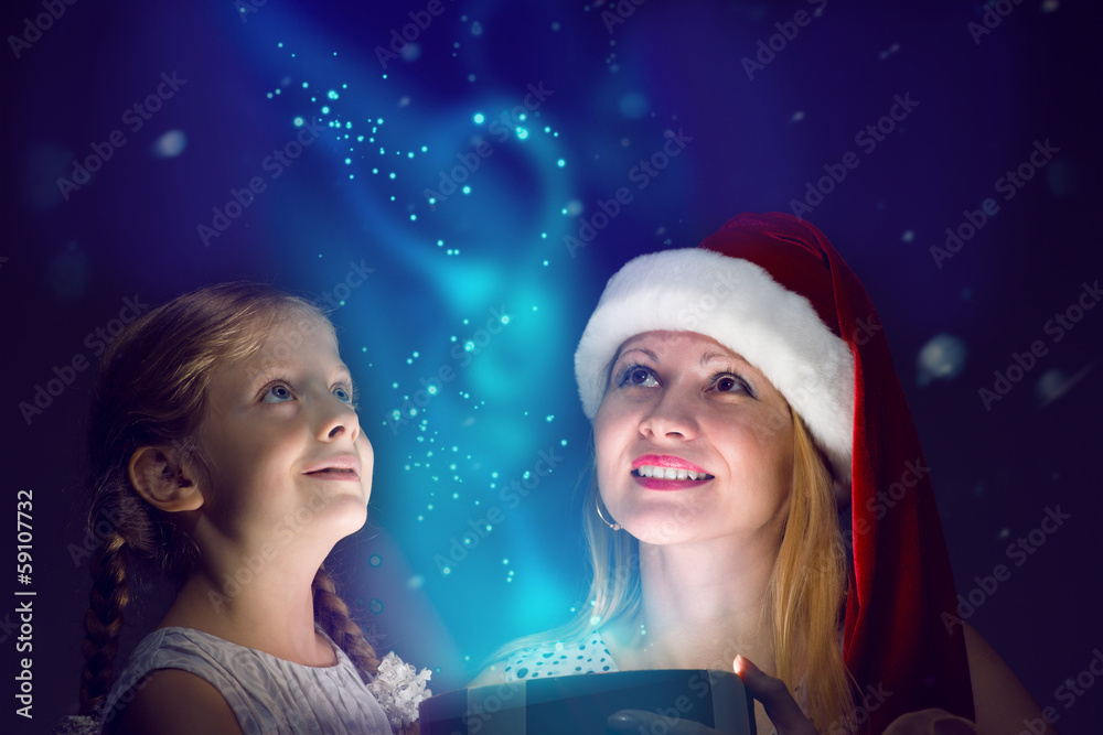 mother and daughter opened a box with a gift mother and daughter opened a box with a gift