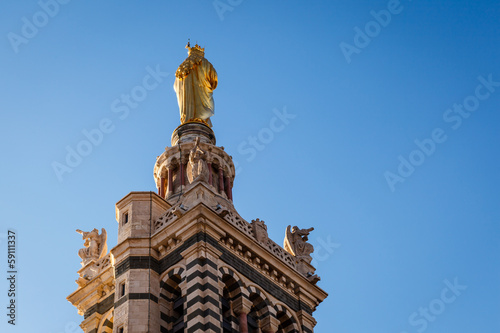 Golden Statue of the Madonna Holding the little Jesus on the top © anshar73