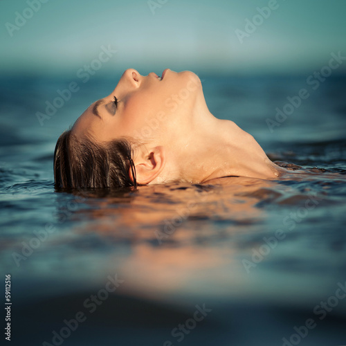 Sensual woman emerging from the water.