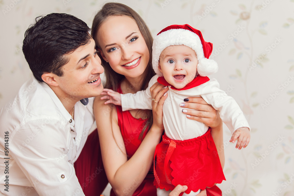 Happy family with cute baby in suit of Santa's little helper Happy family with cute baby in suit of Santa's little helper