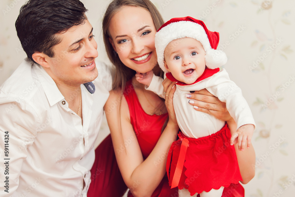 Happy family with cute baby in suit of Santa's little helper Happy family with cute baby in suit of Santa's little helper