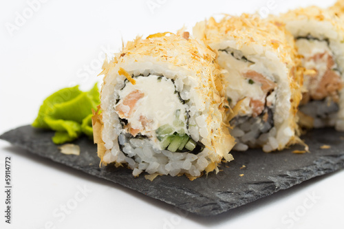Sushi roll on stone plate isolated on white background