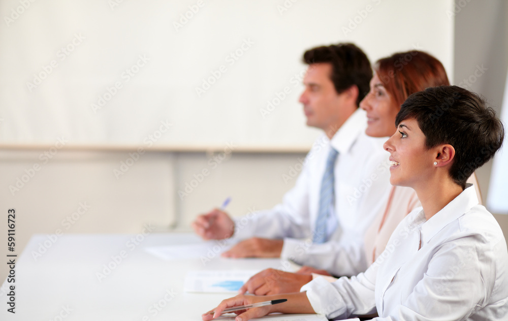 Adult coworker group looking at presentation Adult coworker group looking at presentation